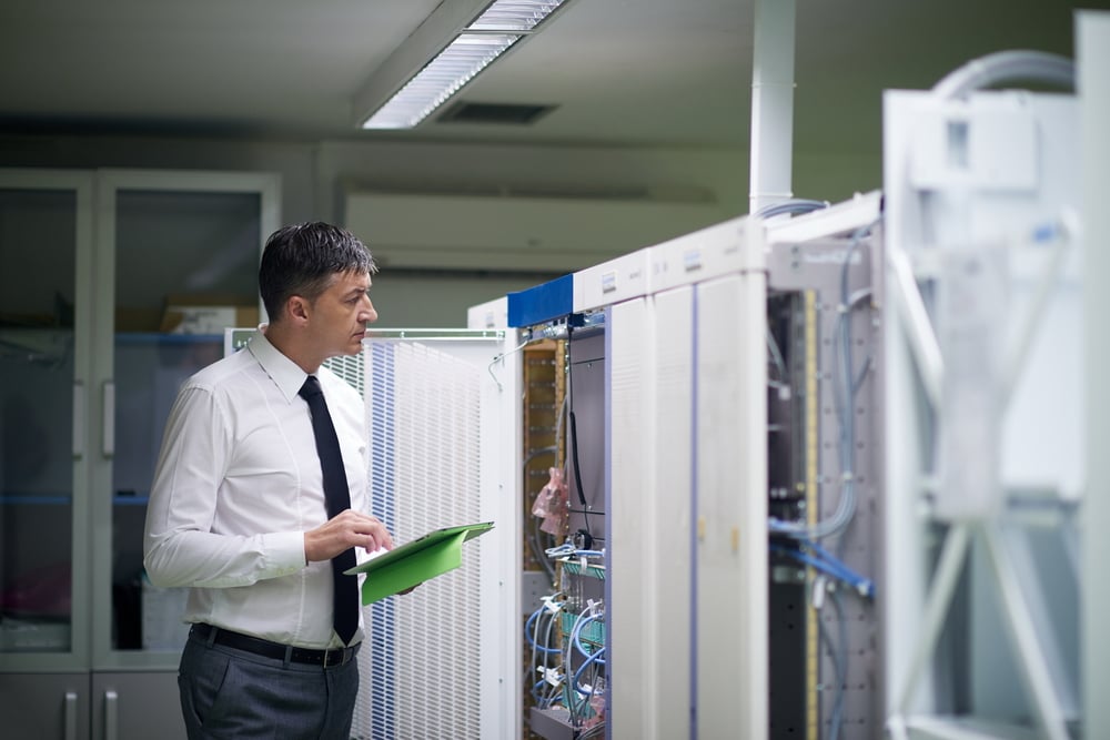 network engineer working in  server room, corporate business man working on tablet computer